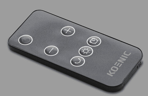 Czarny pilot z białymi przyciskami na jasnoszarej powierzchni.