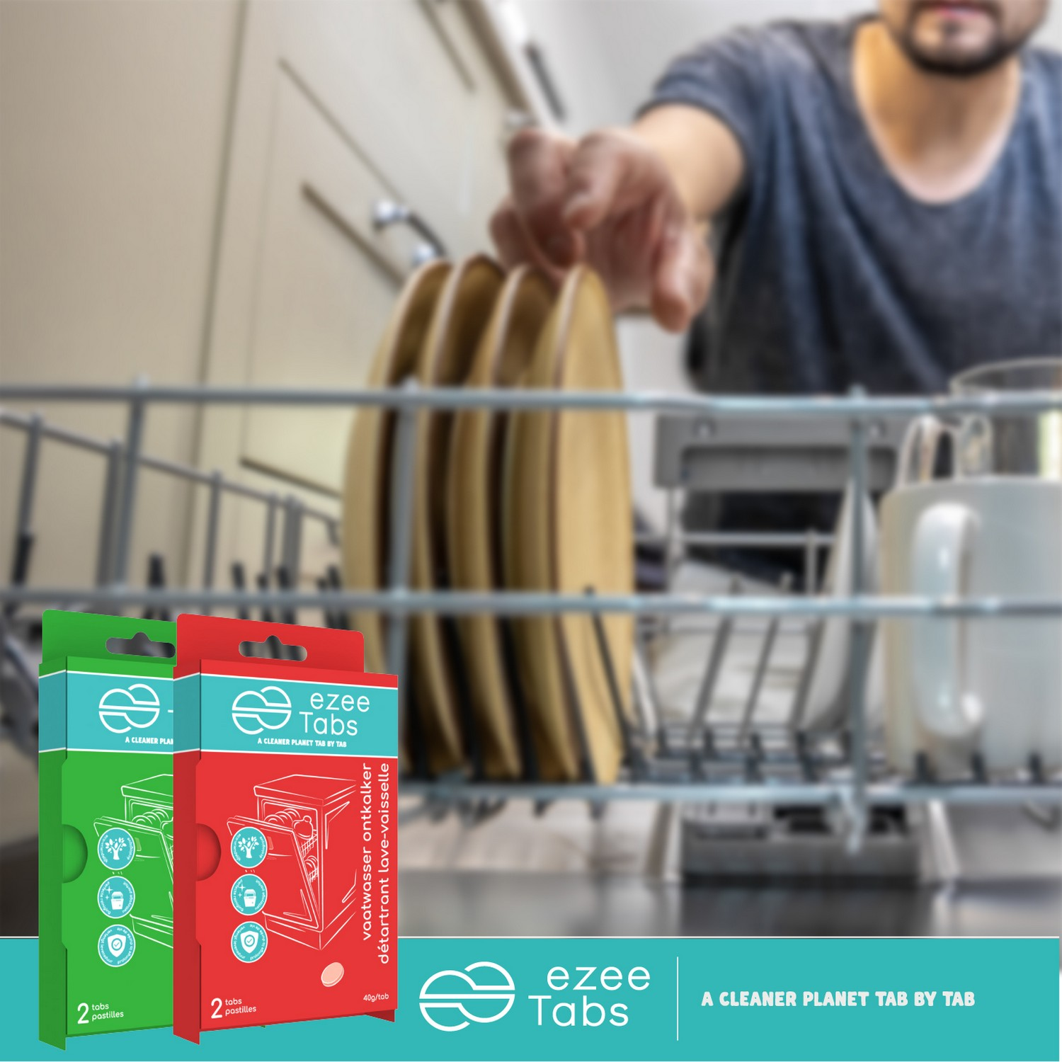 Two boxes of 'ezee Tabs' dishwasher tablets. A person loads a dishwasher with plates in the background.