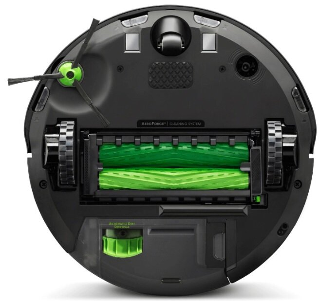 Widok od spodu czarnego odkurzacza Roomba. Widoczne zielone szczotki i koła.