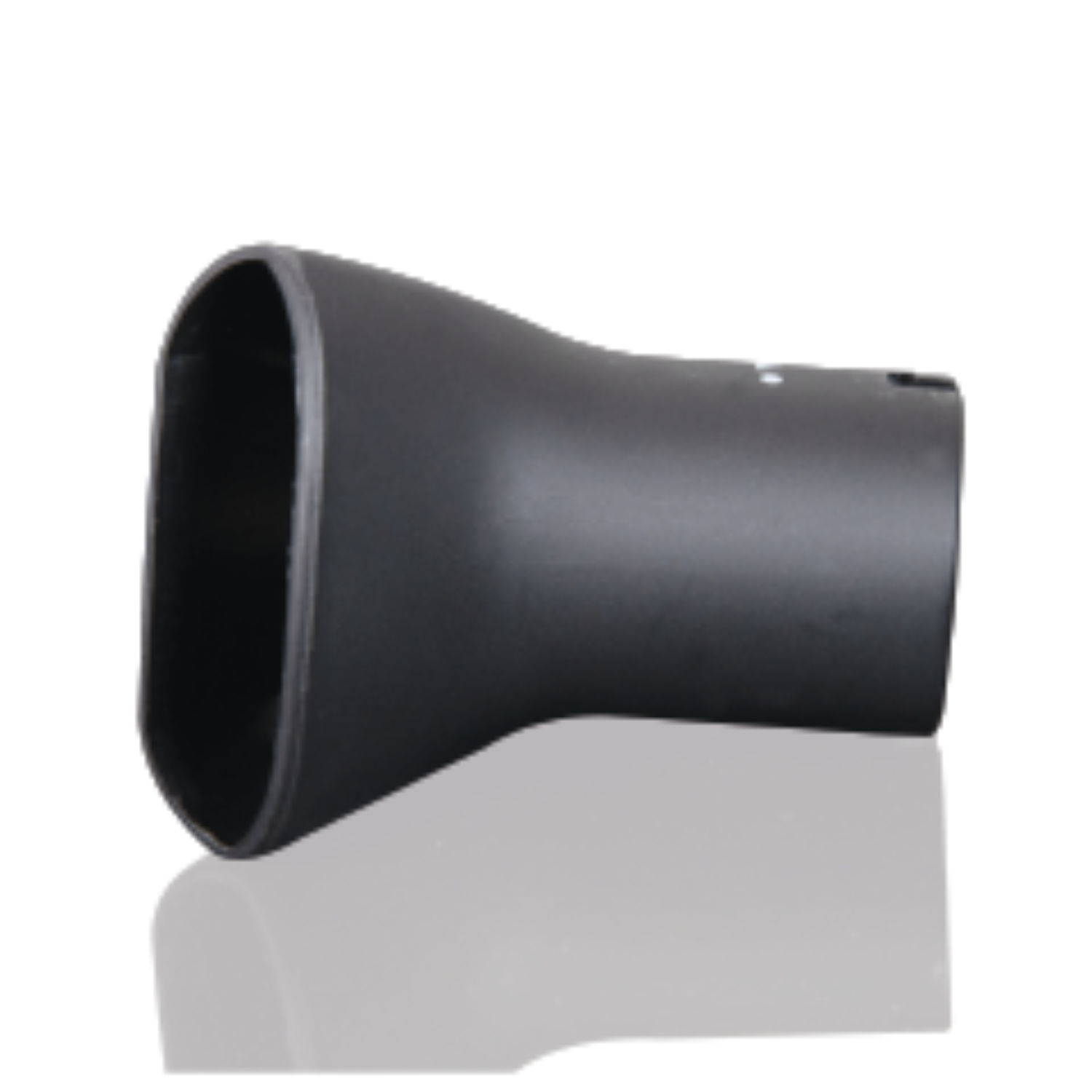 A black, oval-shaped object, possibly a car part, on a white surface, reflecting light.