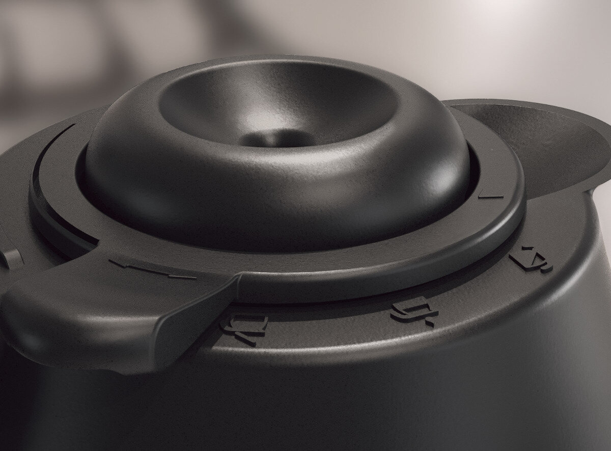 Czarna, okrągła, plastikowa część maszyny.