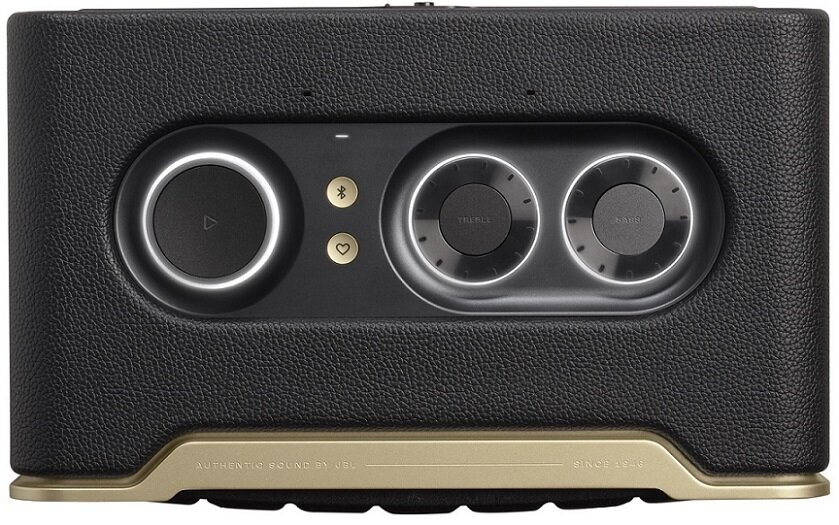 Czarny głośnik ze złotymi akcentami i elementami sterującymi na górze.