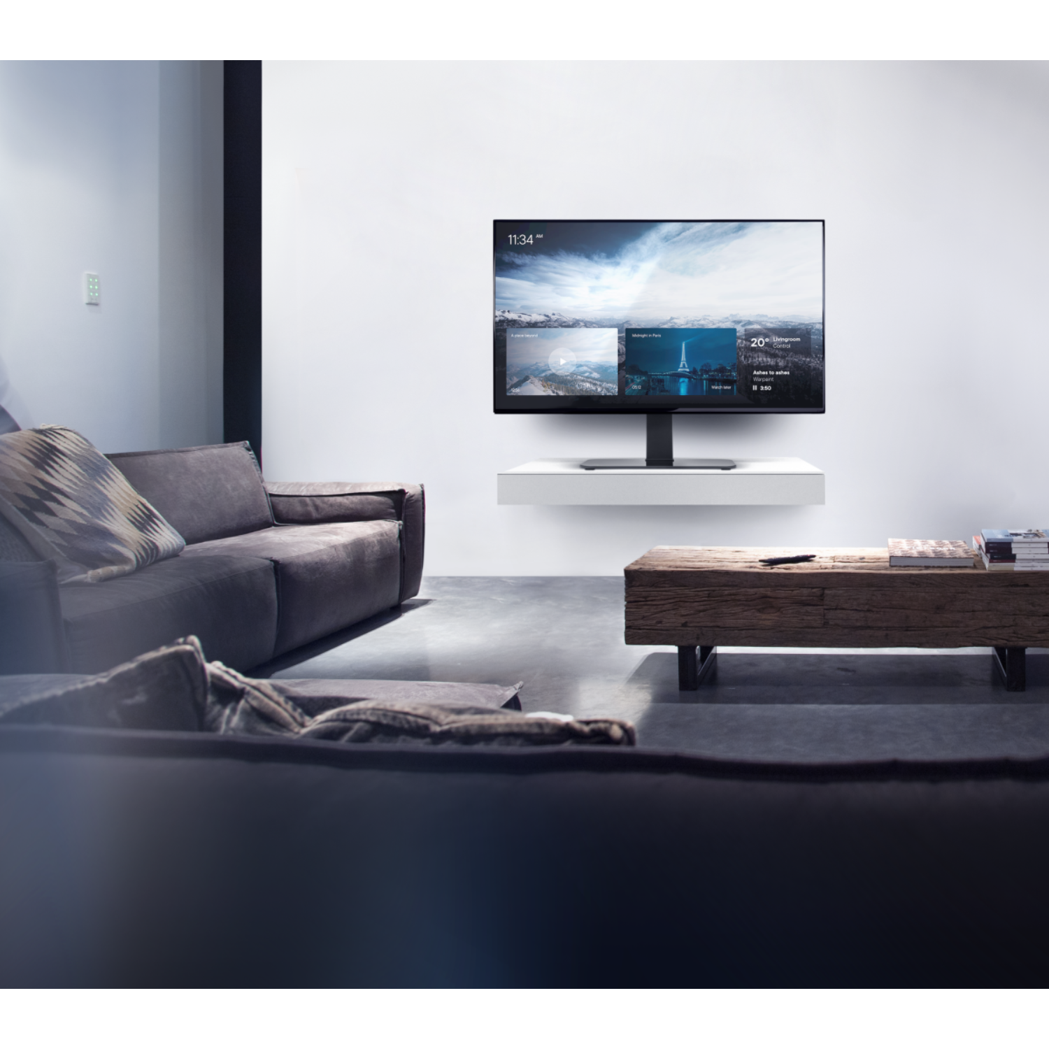 Living room with a large TV on the wall, a couch, and a coffee table.