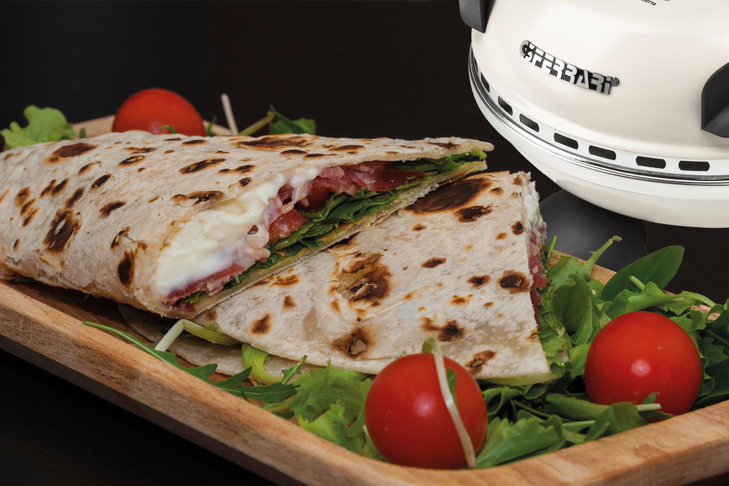 Ein in zwei Hälften geschnittenes Sandwich auf einem Holzbrett. Tomate und Salat sind sichtbar.
