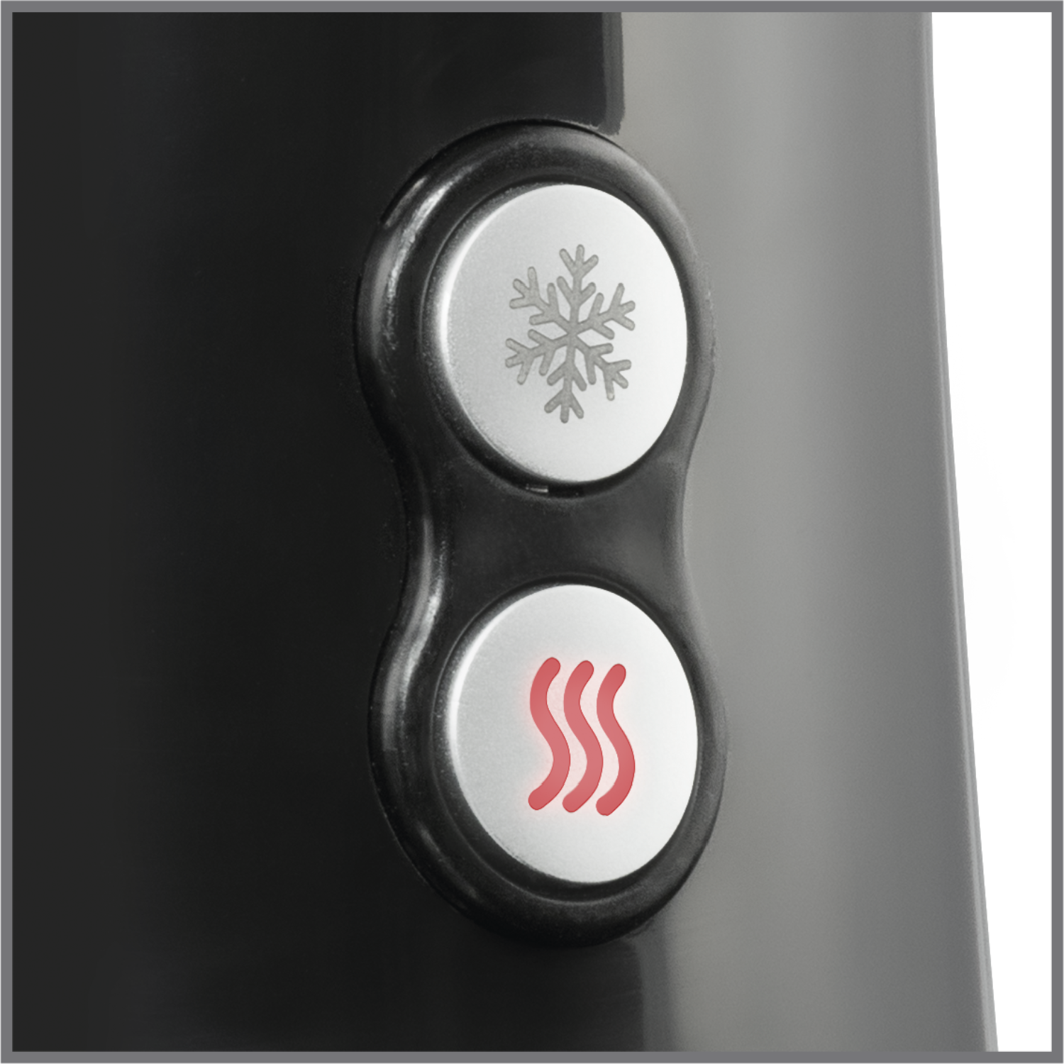 Close-up of black appliance buttons: snowflake and three wavy lines.
