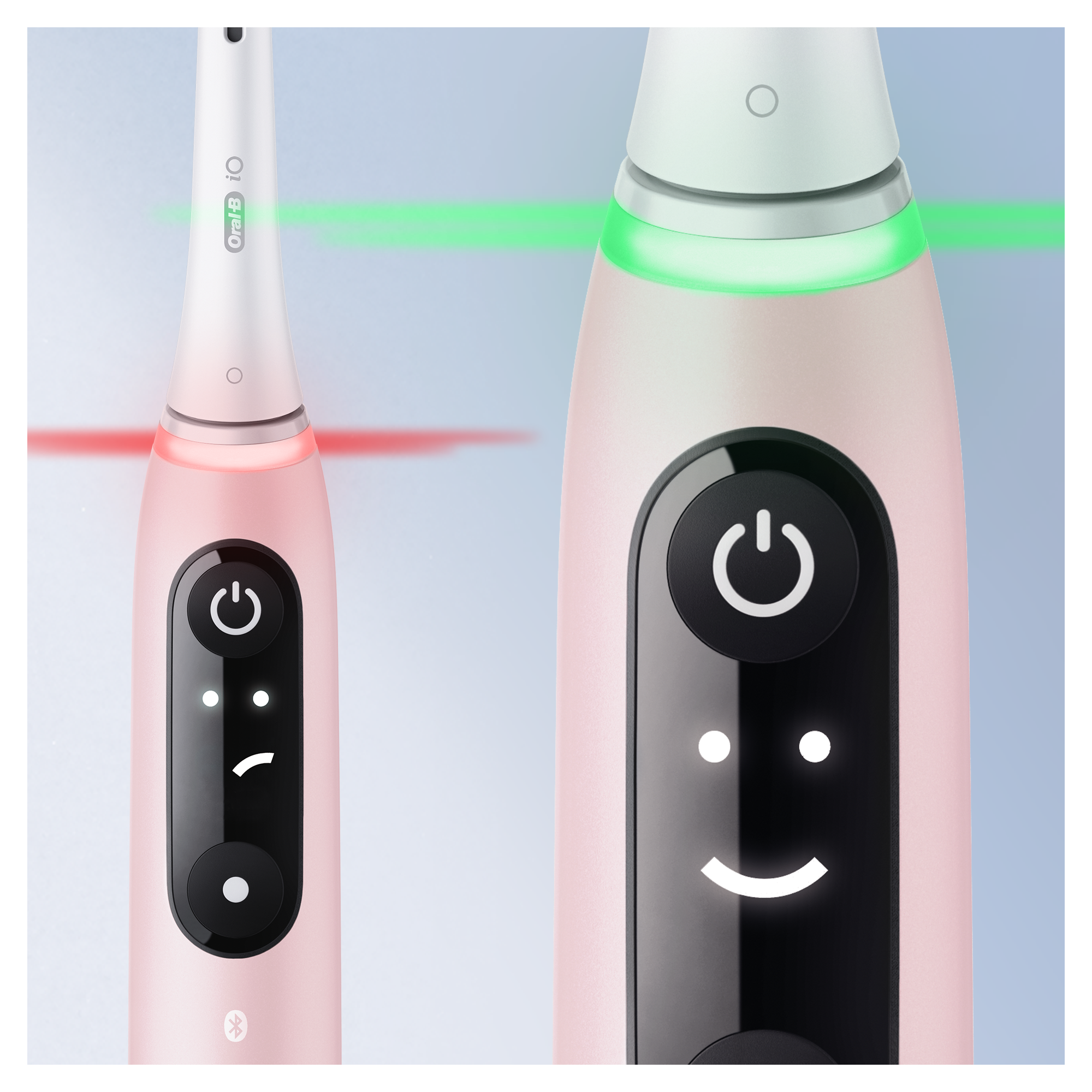 Deux brosses à dents électriques roses avec boutons d'alimentation et lumières.