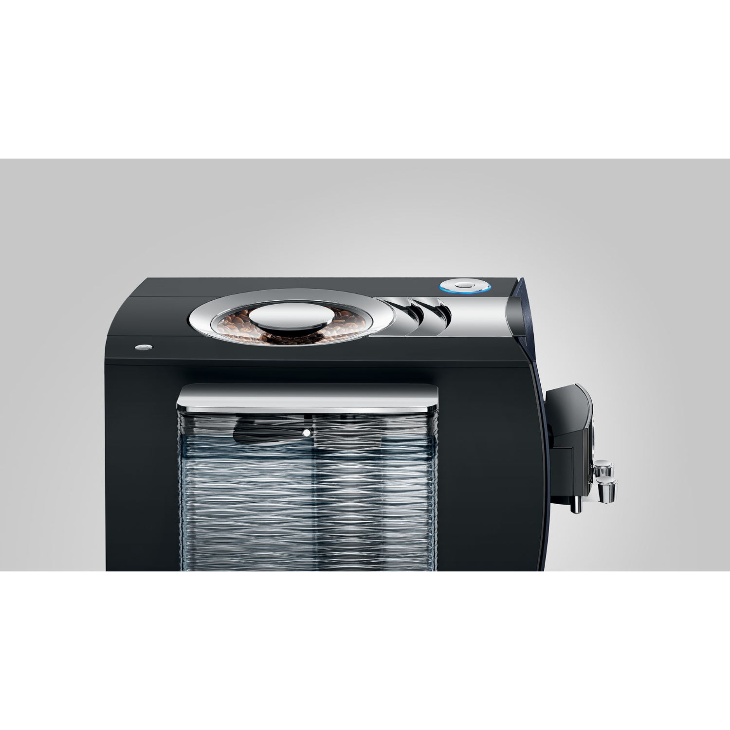 Black Jura automatic coffee machine with coffee beans in a transparent container.