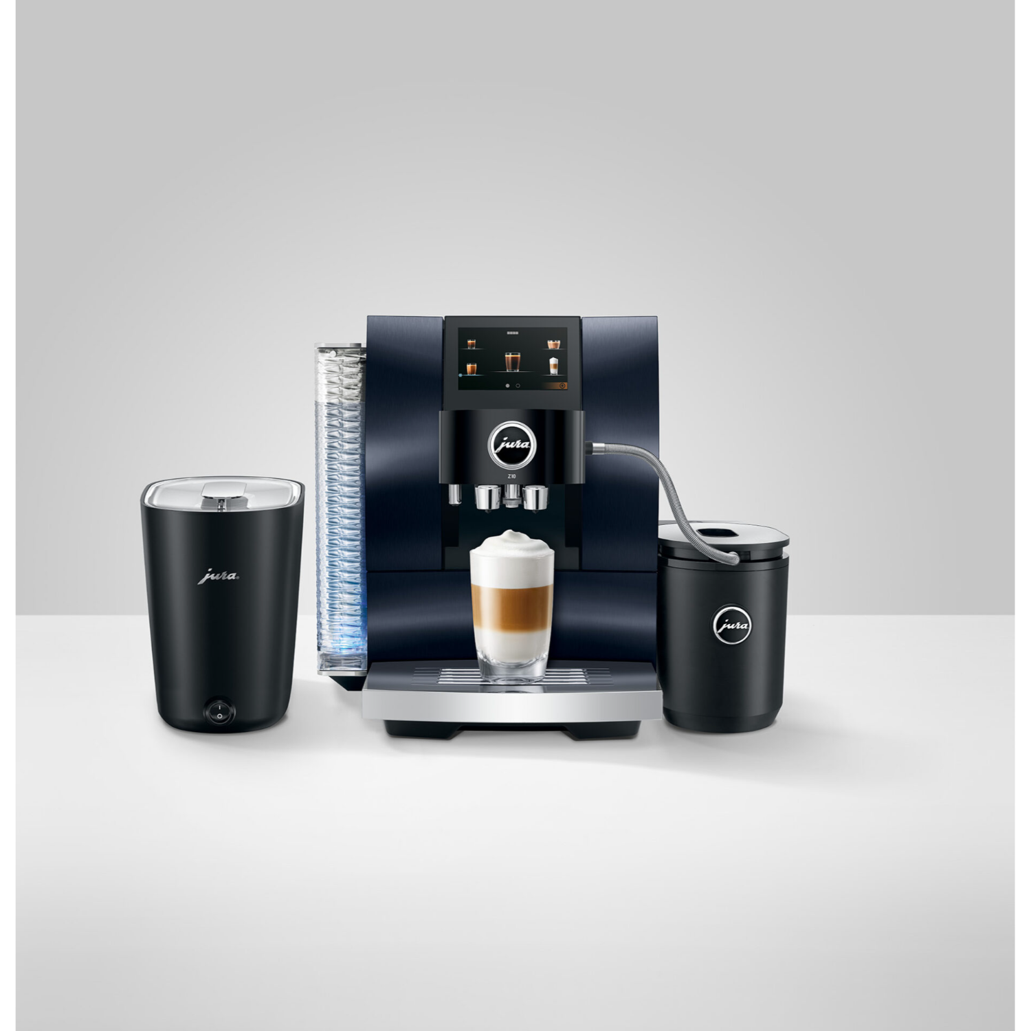 Dark blue coffee machine with milk frother, glass, and mug. Coffee and milk foam displayed.