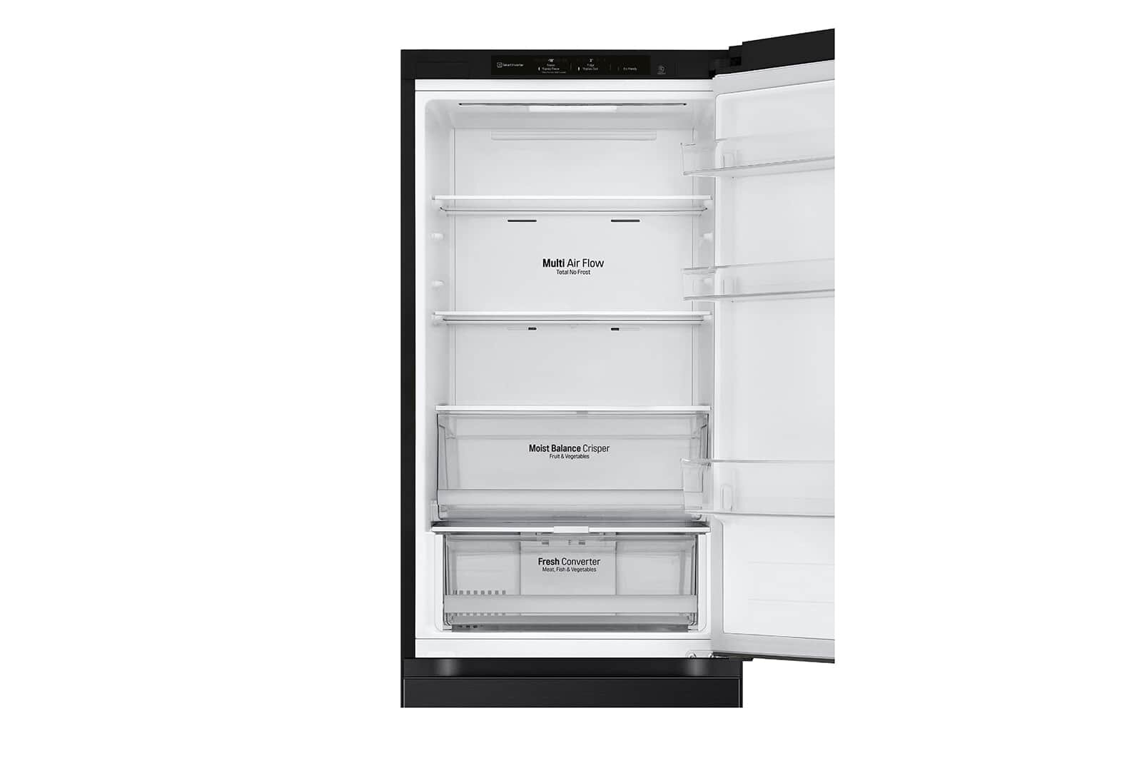 Otwarta lodówka z wieloma przegrodami. Wewnątrz znajdują się szuflady i półki, dobrze oświetlone i czyste.