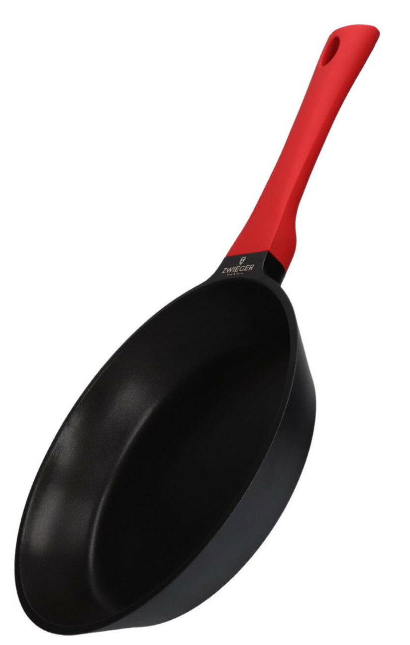 Czarna patelnia z czerwonym uchwytem. Uchwyt ma otwór do zawieszania. Marka jest widoczna na patelni.