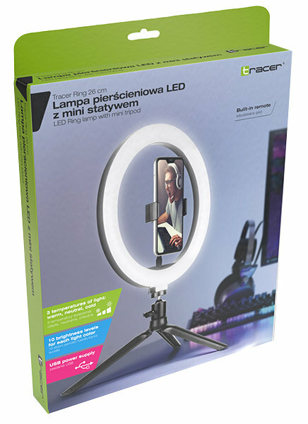 Lampa pierścieniowa z zamontowanym telefonem, na statywie, w pudełku z tekstem, białe tło.