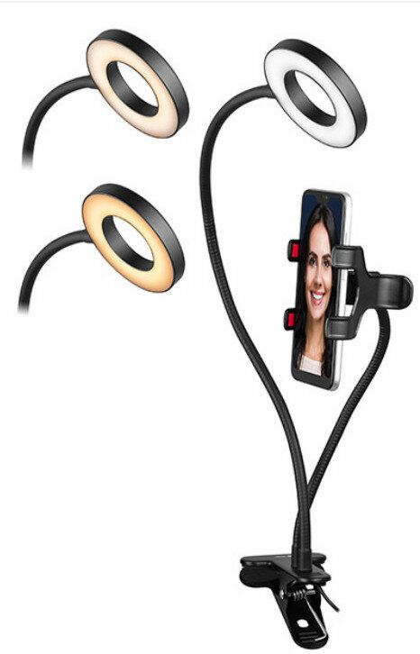 Trzy lampy pierścieniowe z telefonem zamontowanym w zacisku, na białej powierzchni.
