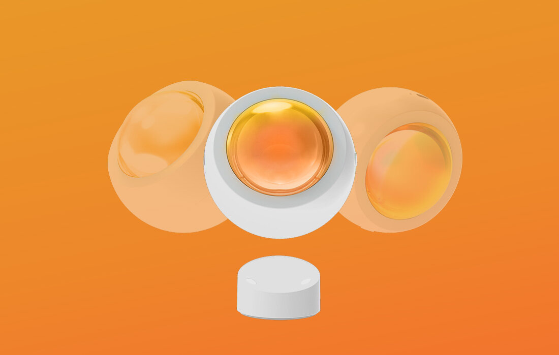 Trzy obiekty w kształcie jaj na pomarańczowym tle, z białym walcem poniżej.