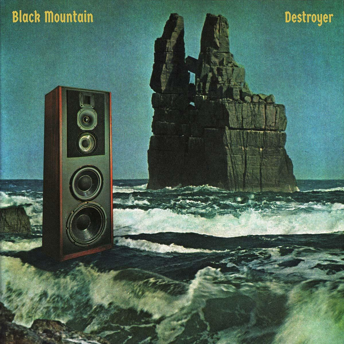 Albumcover mit Lautsprecher und Felsformation.