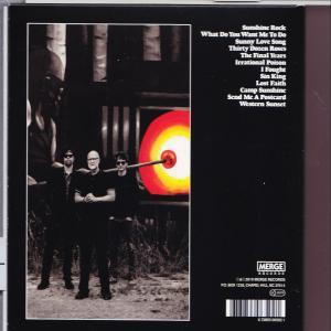 Rückseite einer CD-Hülle. Vier Männer stehen vor einer Glasbläserszene. Text listet Songtitel auf.