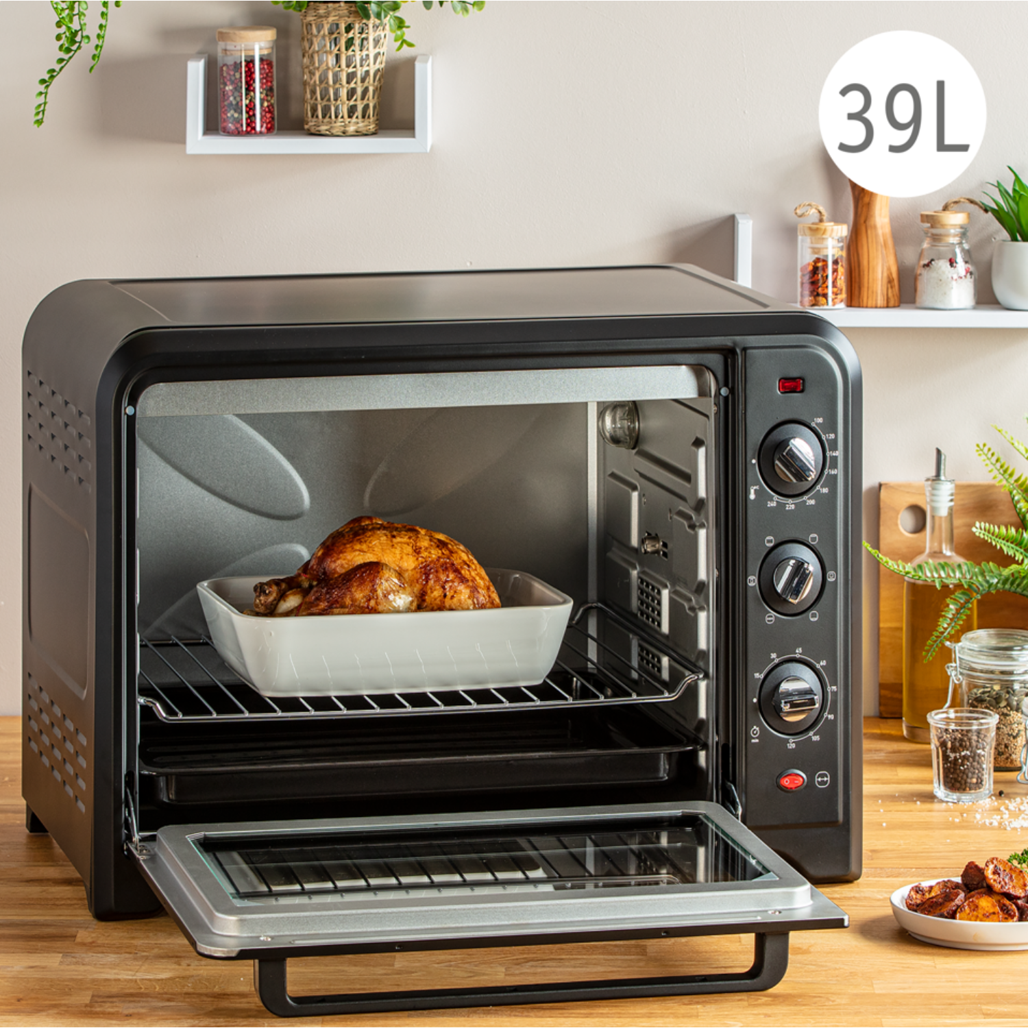 Black oven with open door, a roasted chicken in a white dish inside.