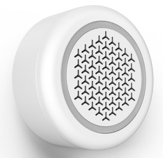 Biały, okrągły głośnik na ścianie. Ma teksturowany środek i szarą obwódkę.