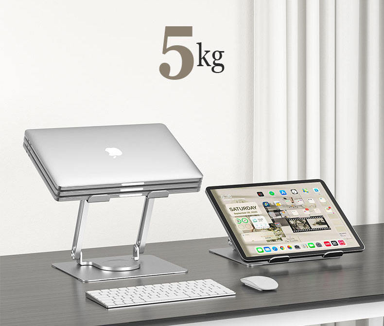 Dizüstü bilgisayar ve tablet standlarda. Önünde klavye ve fare var. Üstte 5 kg ağırlık gösteriliyor.