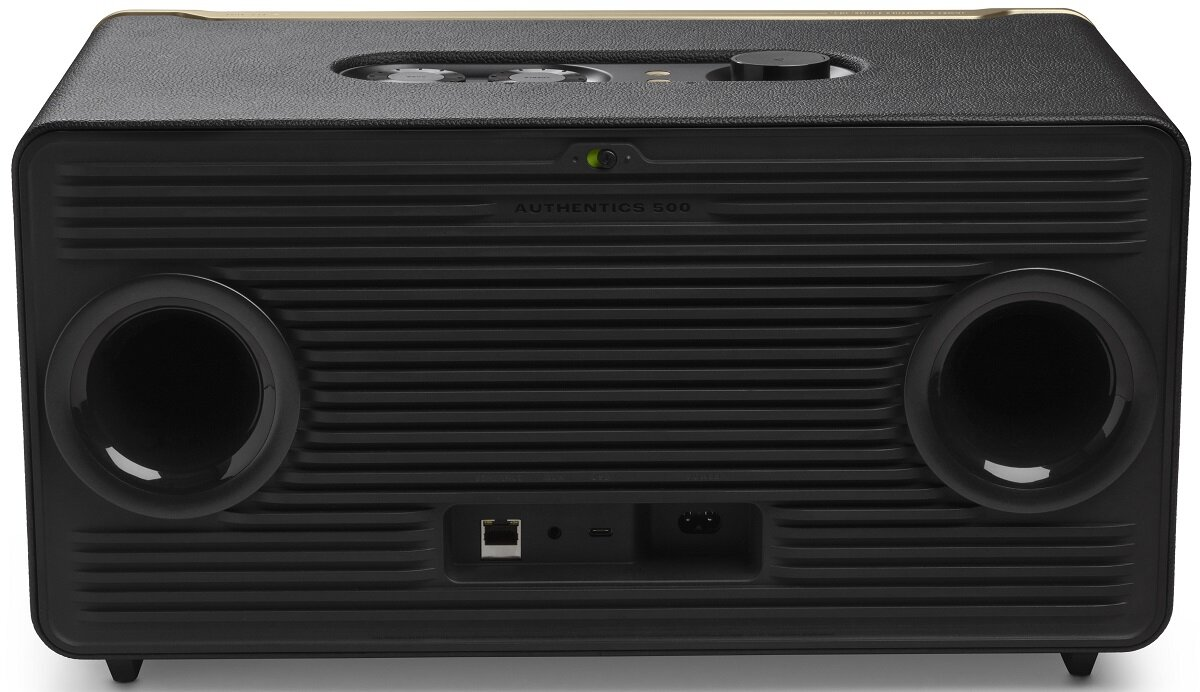 Czarny głośnik z dwoma dużymi okrągłymi otworami głośnikowymi i panelem sterowania.