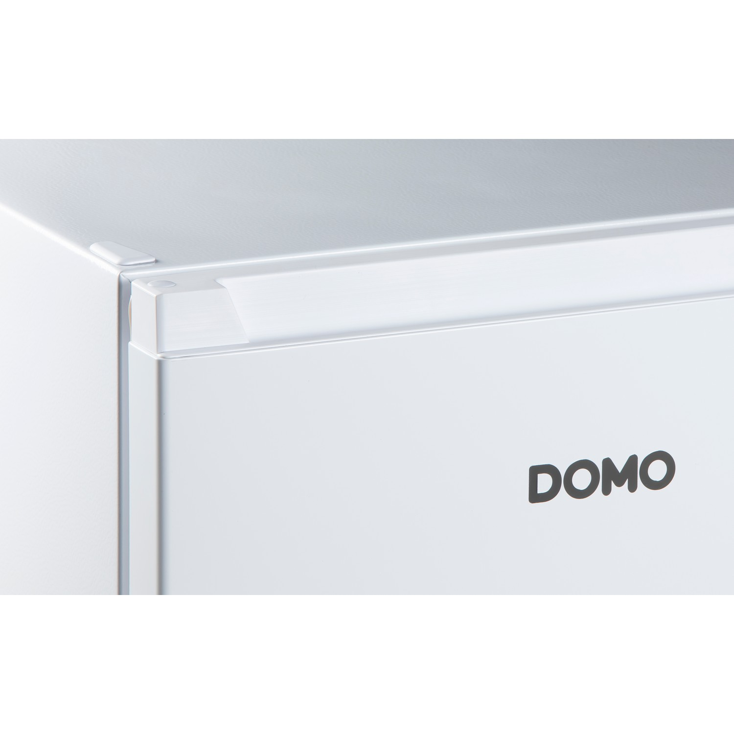 Close-up of a white DOMO refrigerator's door. Black DOMO logo.