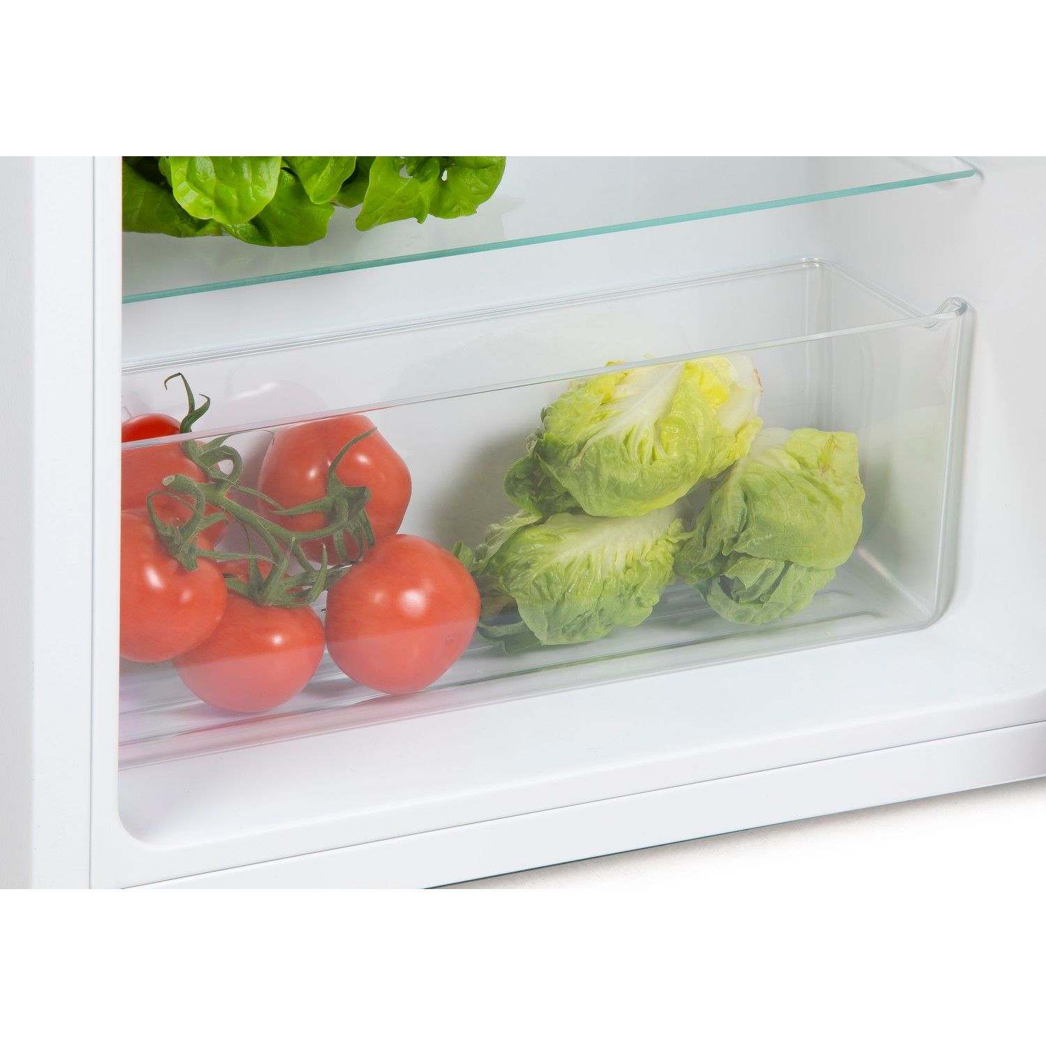 A glass container inside a refrigerator, filled with tomatoes and lettuce. The setting is a white fridge.