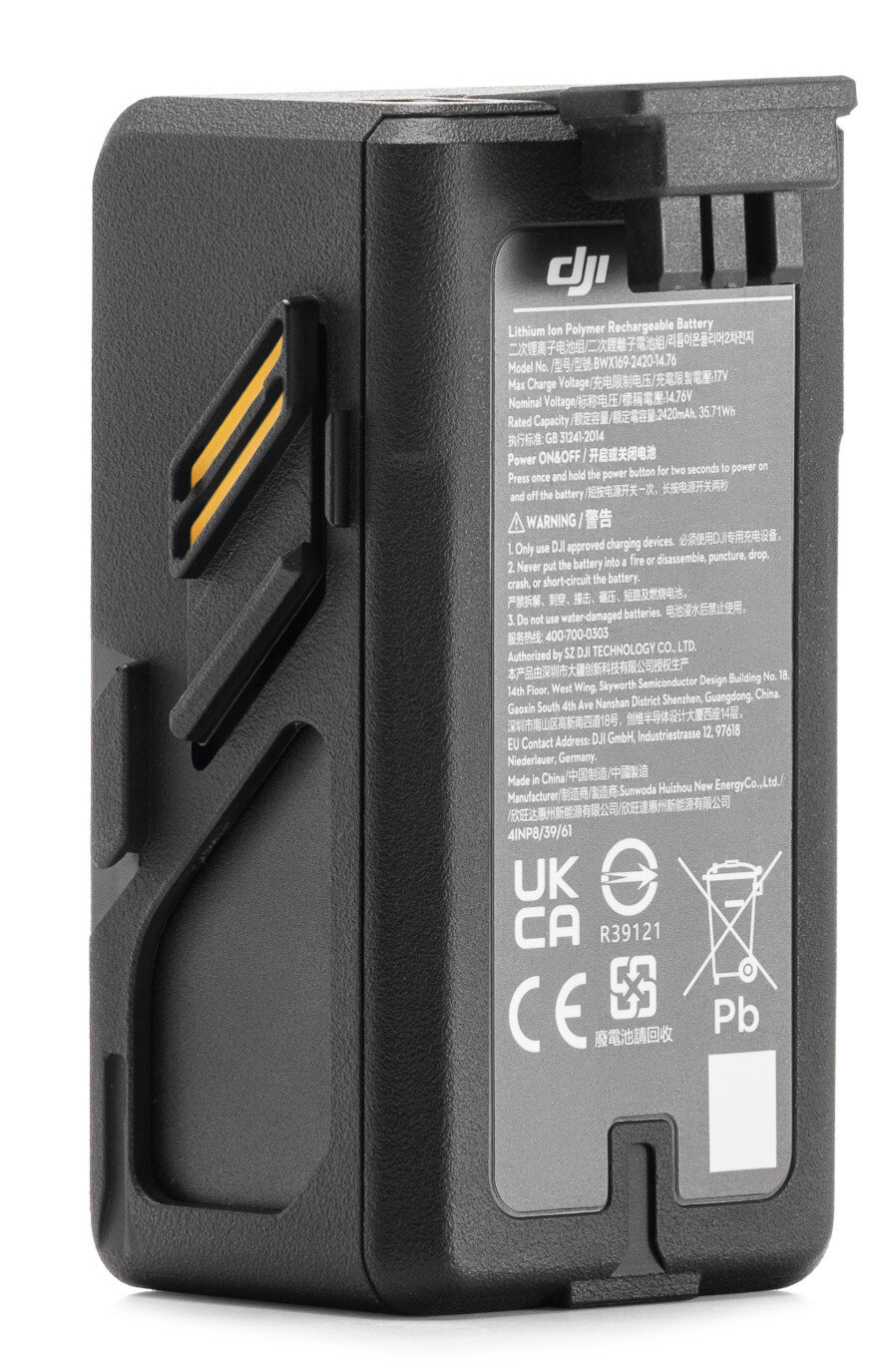 Czarny akumulator drona z etykietami i ostrzeżeniami. Akumulator ma port ładowania i przycisk zasilania.