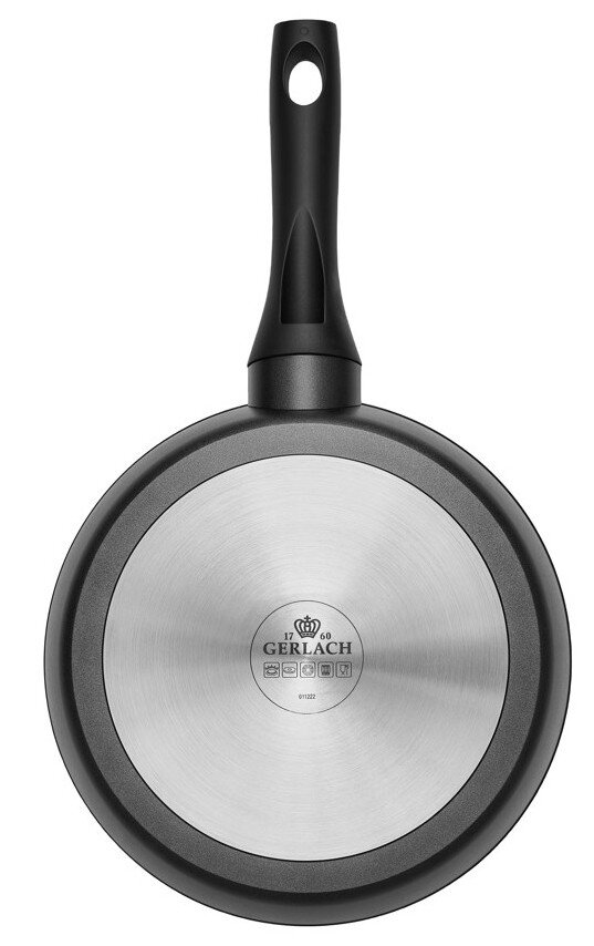 Spód czarnej patelni ze srebrną, okrągłą podstawą.