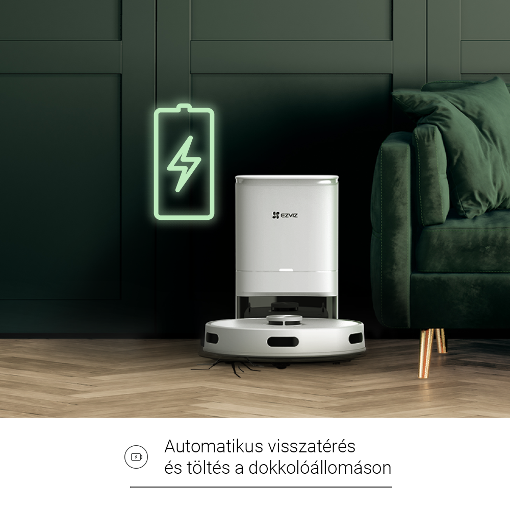 Egy fehér robotporszívó töltőállomással és egy zöld akkumulátor ikonnal felette.