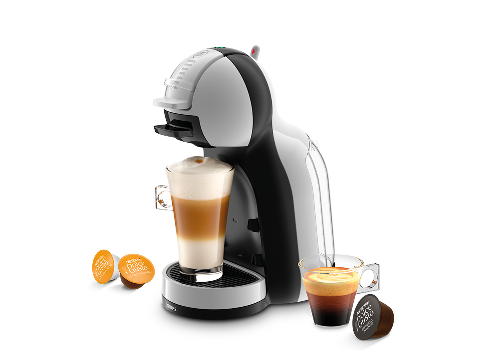 Eine weiß-schwarze Krups Dolce Gusto Kaffeemaschine mit zwei Kaffeetassen.