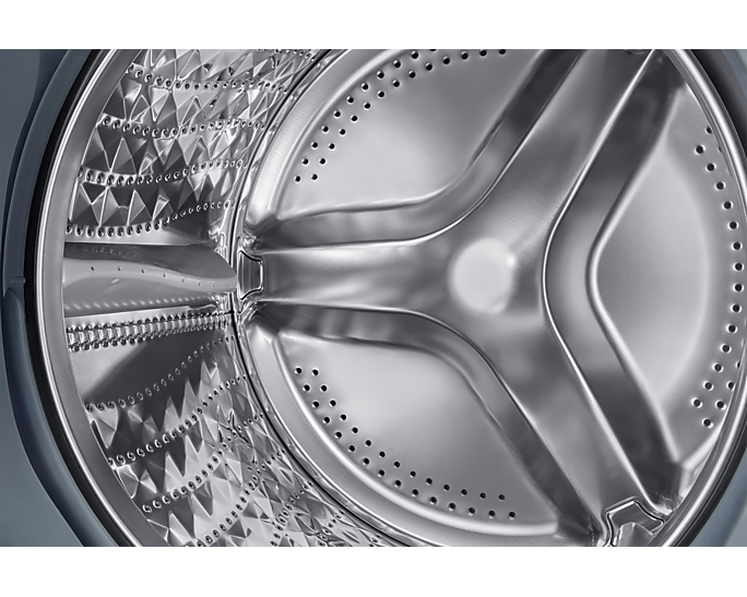 Mosógép dobjának belső közelképe. Rozsdamentes acél, texturált mintával és perforációkkal.