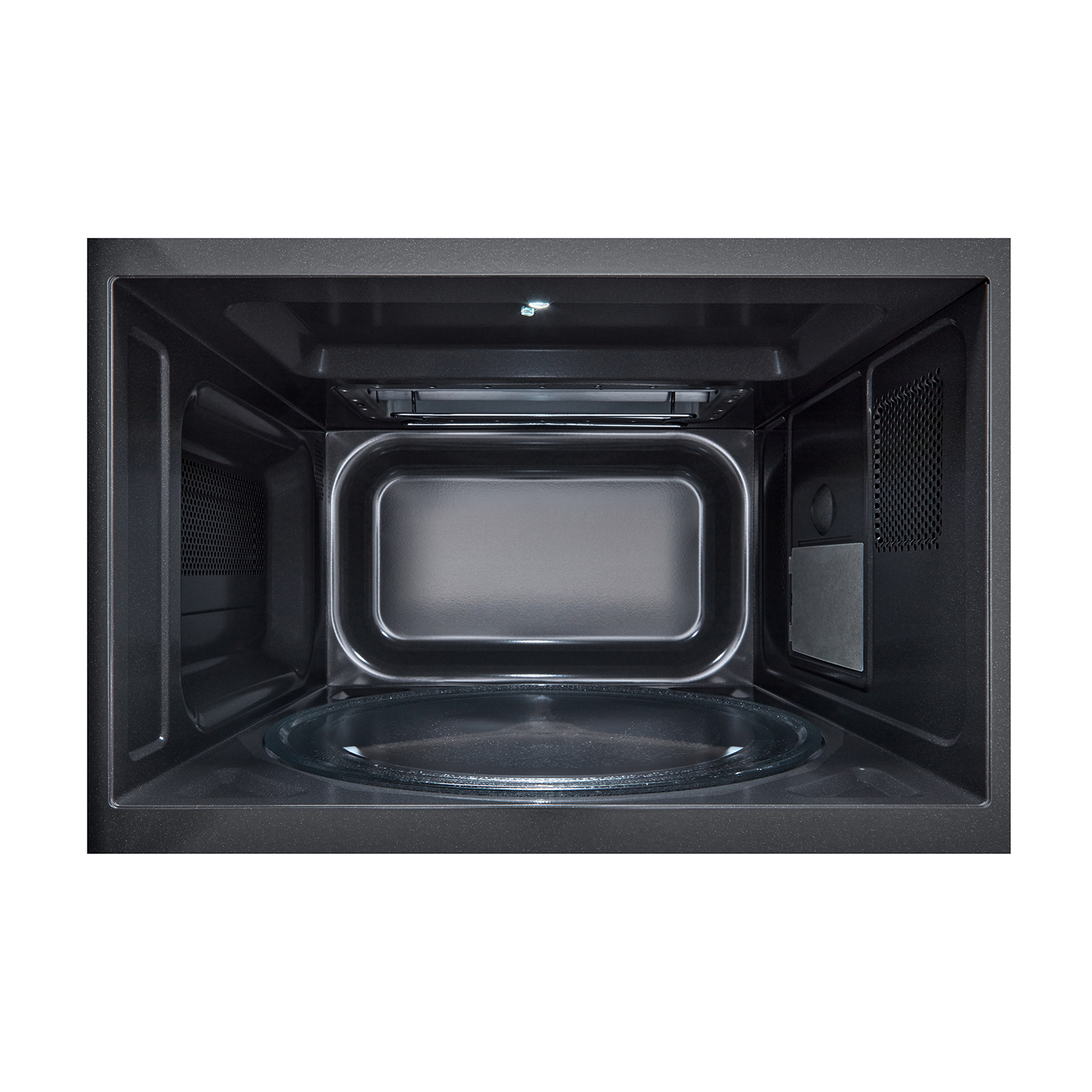 Interno di un forno a microonde nero. Piatto in vetro visibile. Interno scuro, lampada in alto.