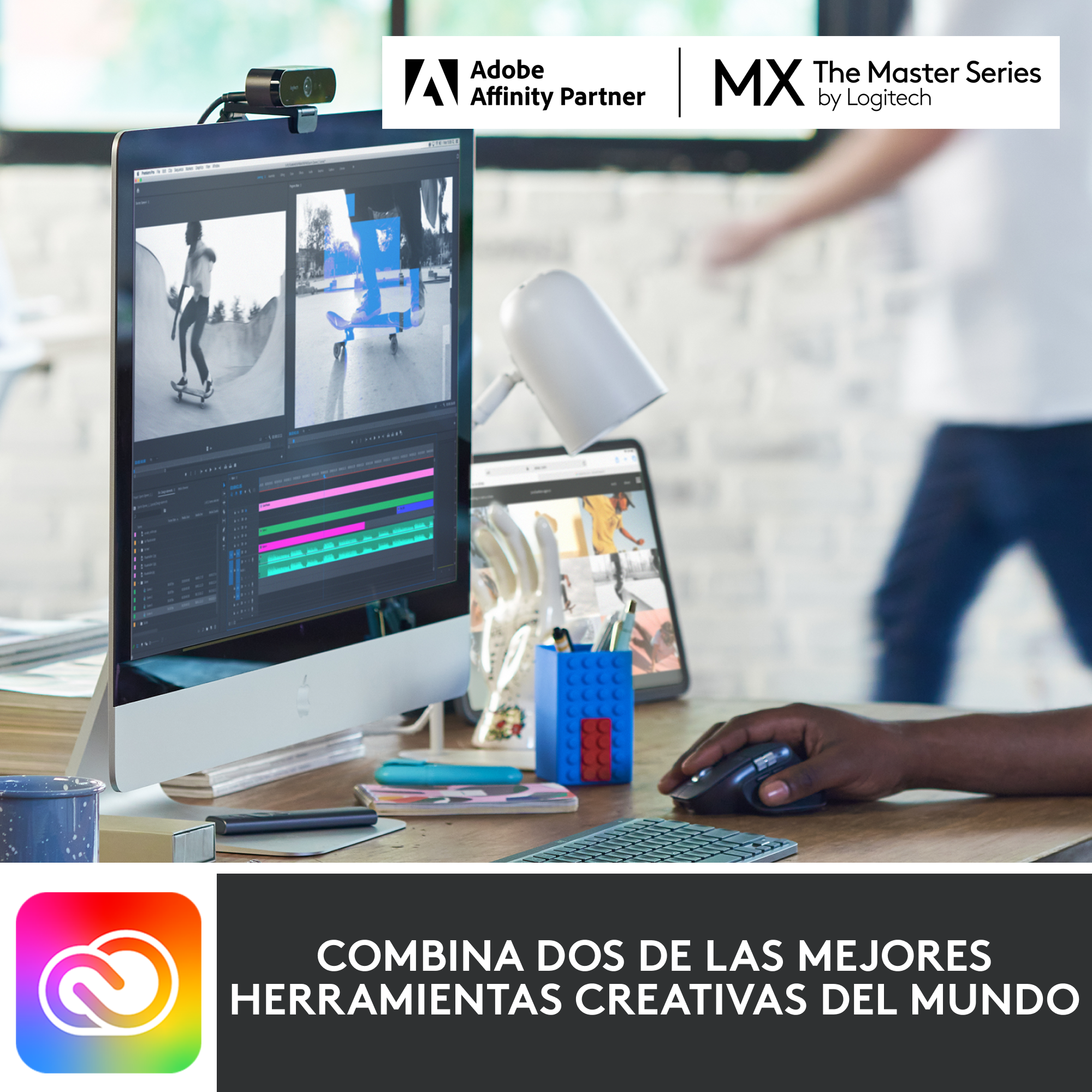 Una configuración de escritorio con monitor, tableta, webcam y una mano en el ratón.