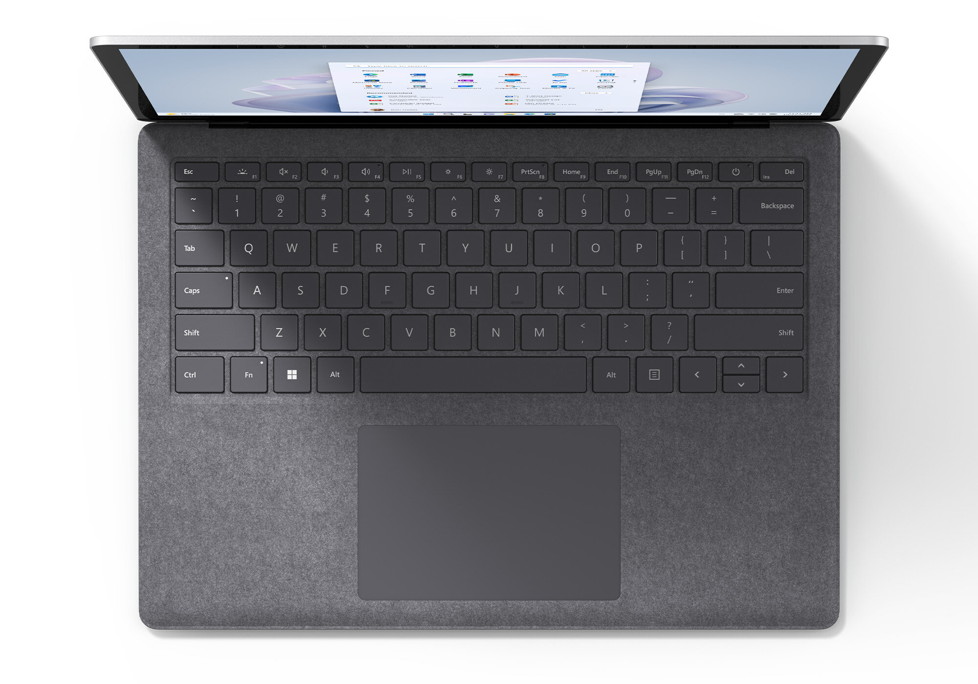 Laptop, widok z góry, otwarty. Szara obudowa, czarna klawiatura, ekran z danymi.