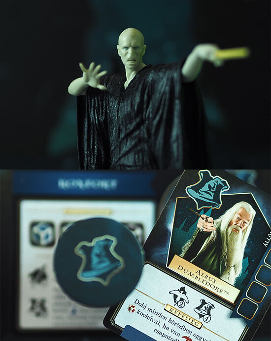 Voldemort figura és Harry Potter kártyajátékok. A kártyák, a zseton és egy pálca az asztalon.