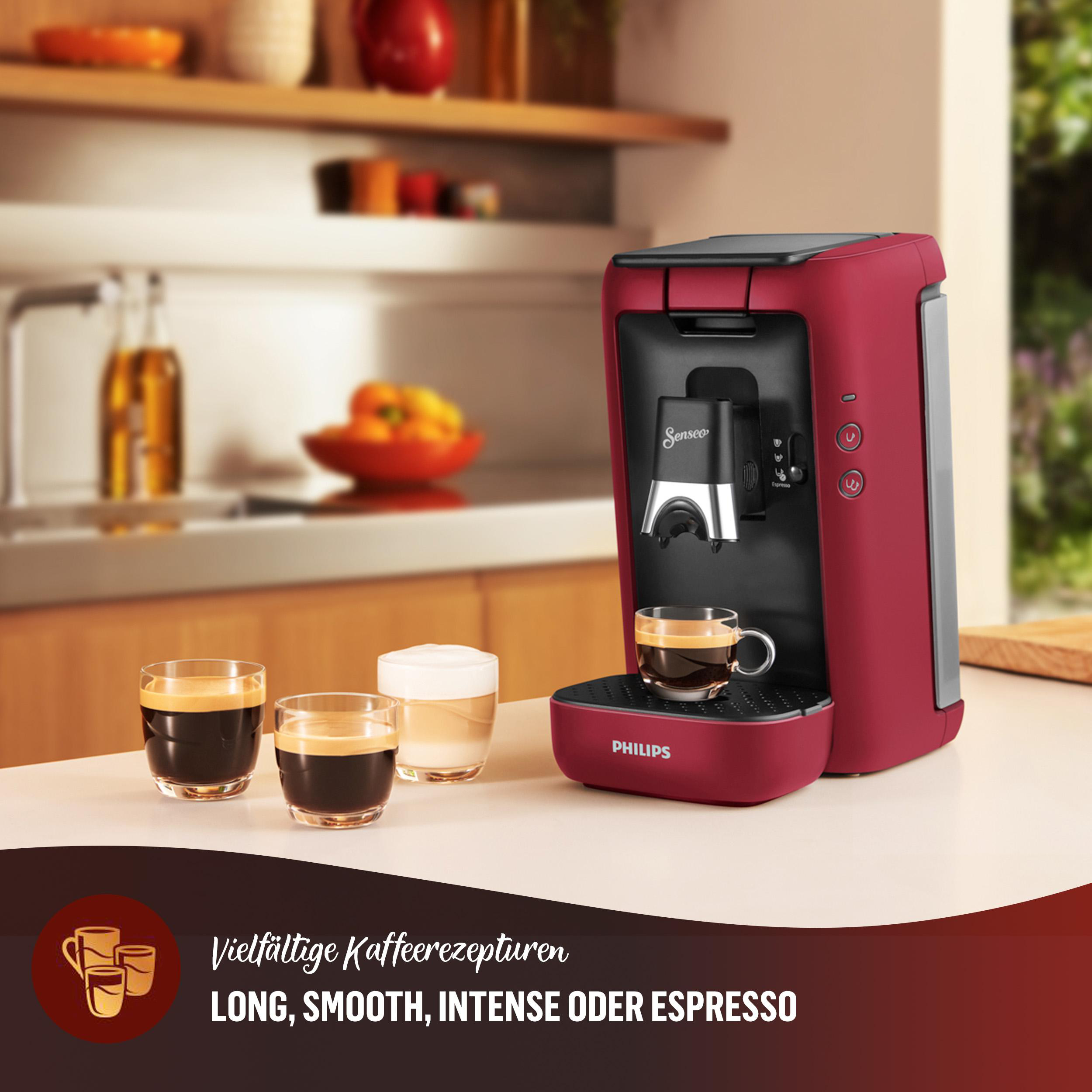 Rote Philips Senseo Kaffeemaschine. Drei Kaffeetassen auf der Theke. Text unten.