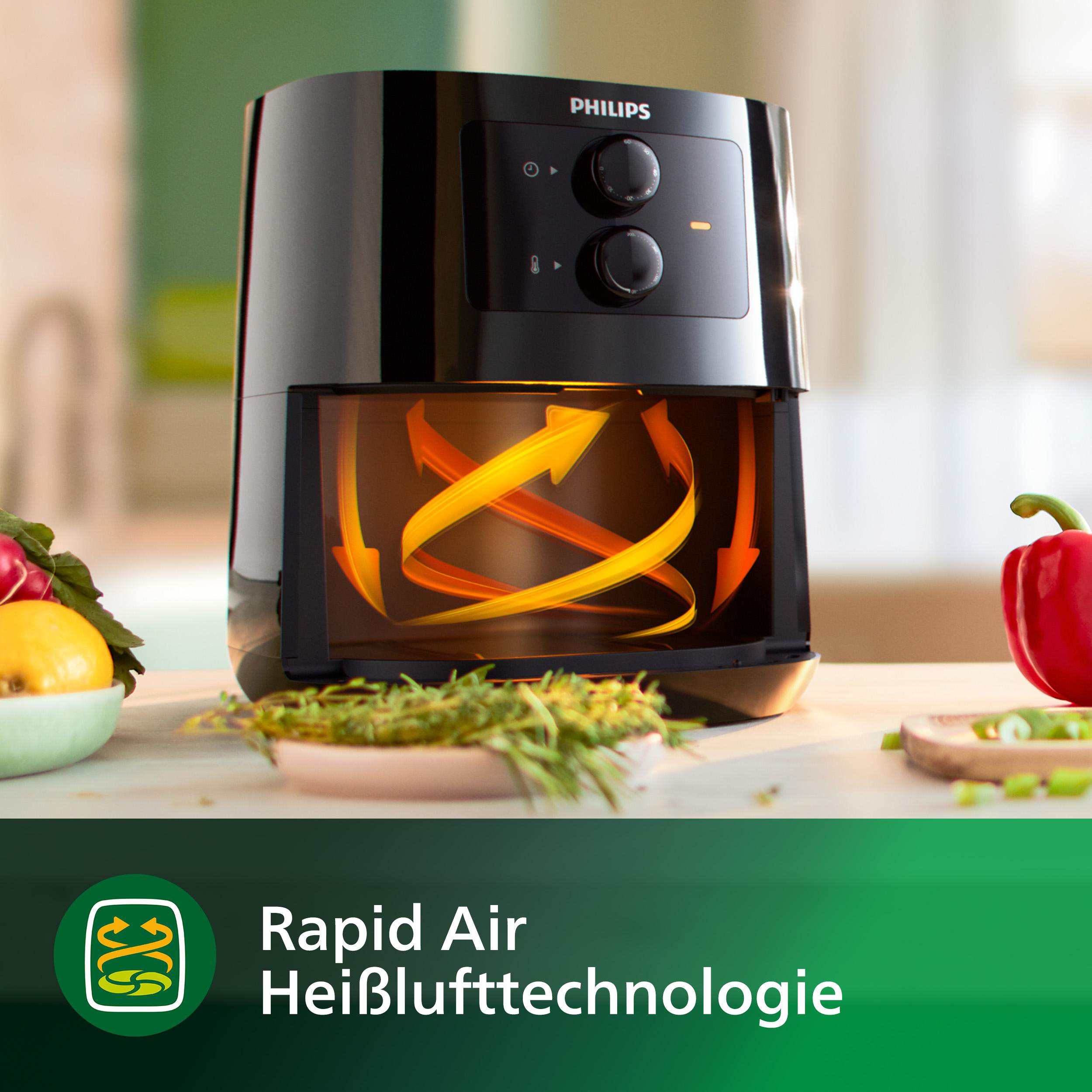 Schwarze Philips Heißluftfritteuse mit Lebensmittelzubereitung und Rapid Air Technologie-Logo.