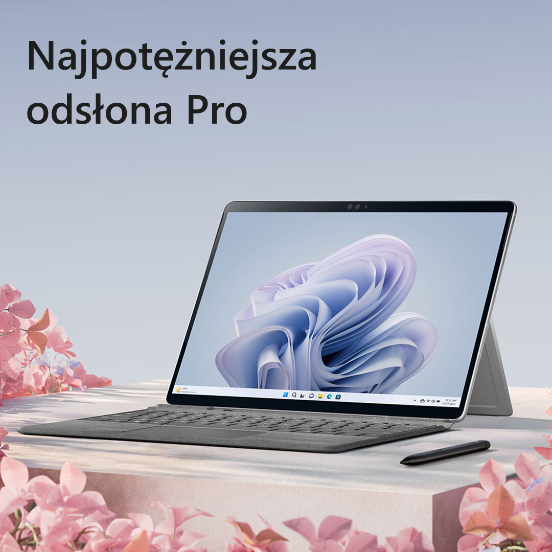 Tablet z klawiaturą, piórem i różowymi kwiatami. Widoczne są słowa "Najpotężniejsza odsłona Pro".