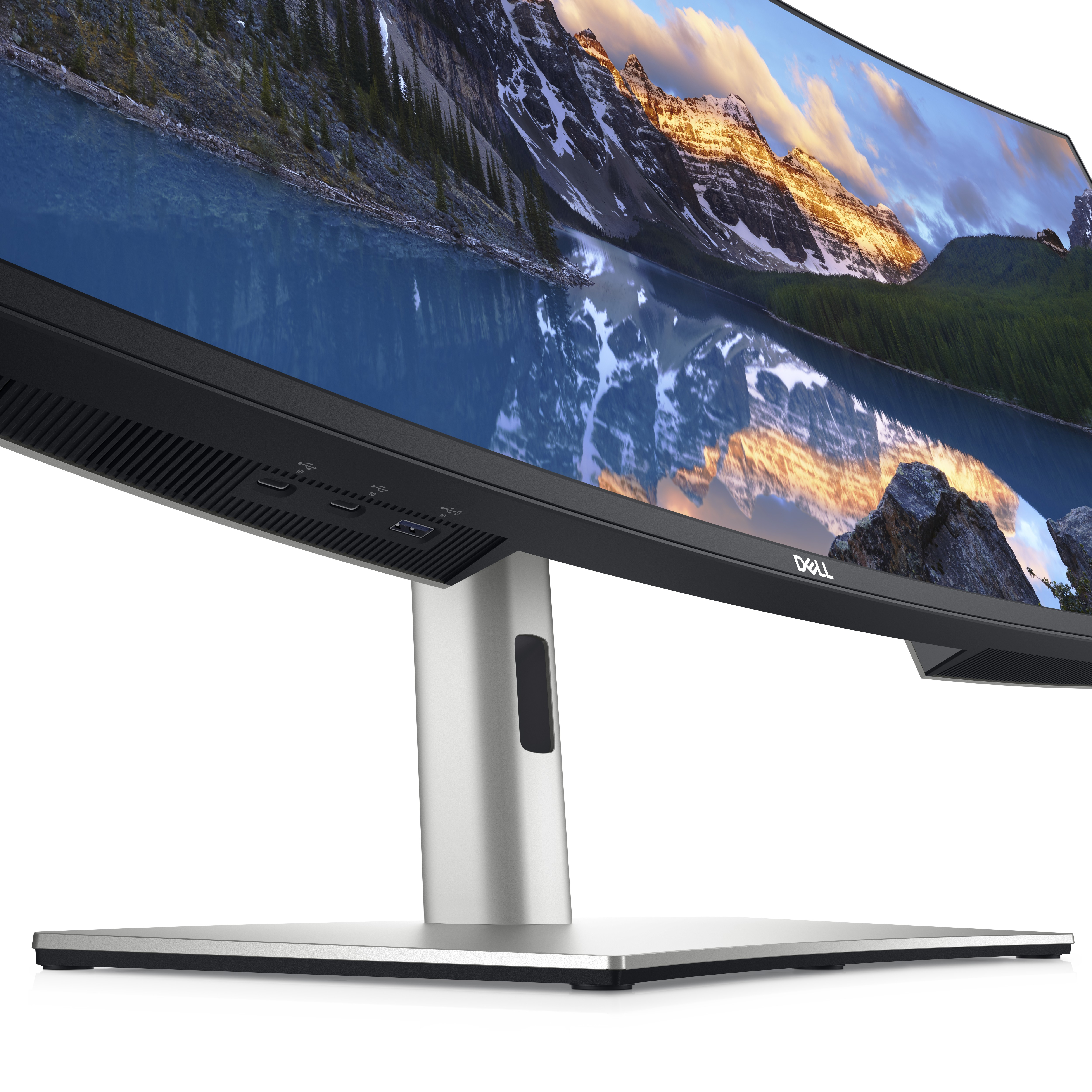 Ein Dell-Monitor mit einer malerischen Kulisse aus See und Bergen. Der Monitor hat einen silbernen Ständer.