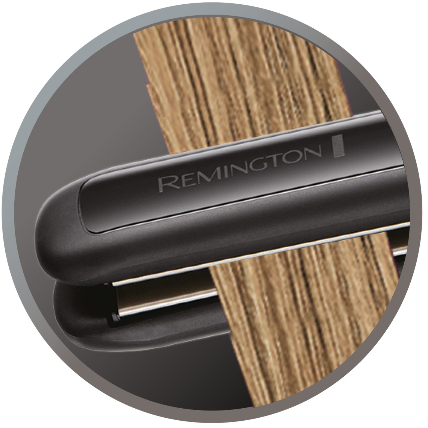 A close-up of a black hair straightener with the name 'Remington'. Blonde hair is in it.