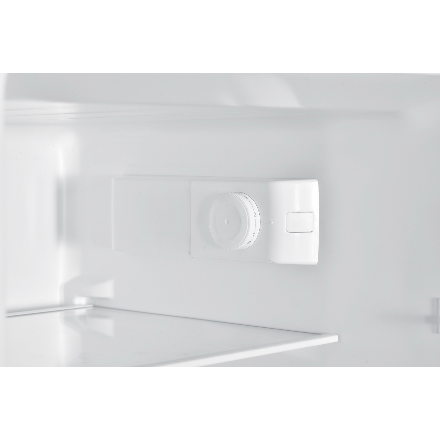 Inside of a white refrigerator, showing the temperature control panel.