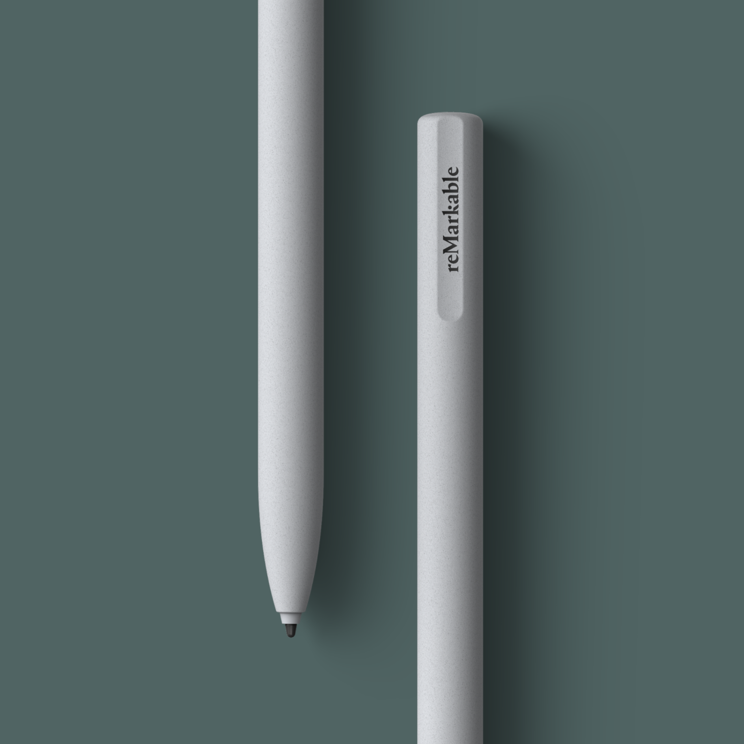 Two gray Remarkable styluses on a green background. One is lying down, the other standing.