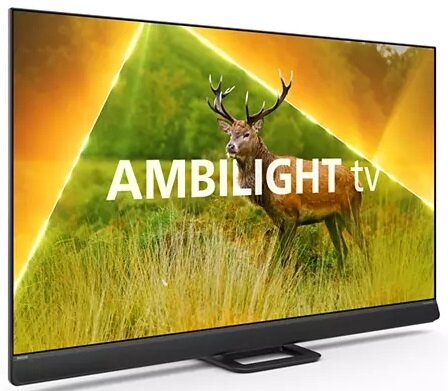 Duży telewizor wyświetla jelenia na polu. Na ekranie wyświetlane jest słowo AMBILIGHT.
