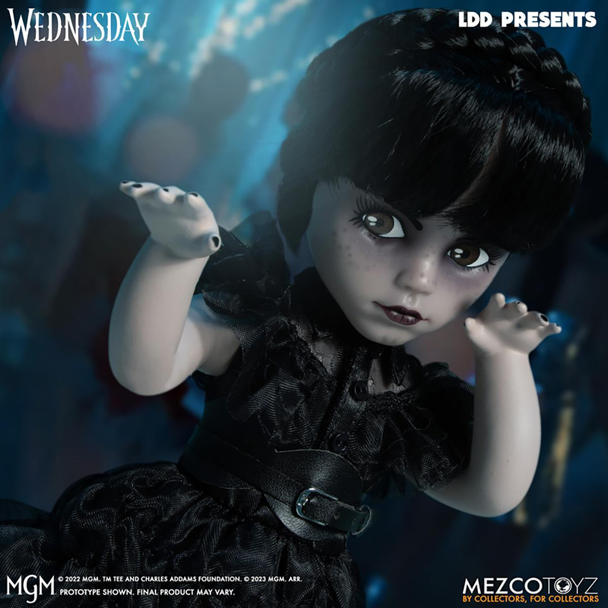 Eine Puppe von Wednesday Addams in einem schwarzen Kleid, mit blassem Gesicht und dunklem Haar.