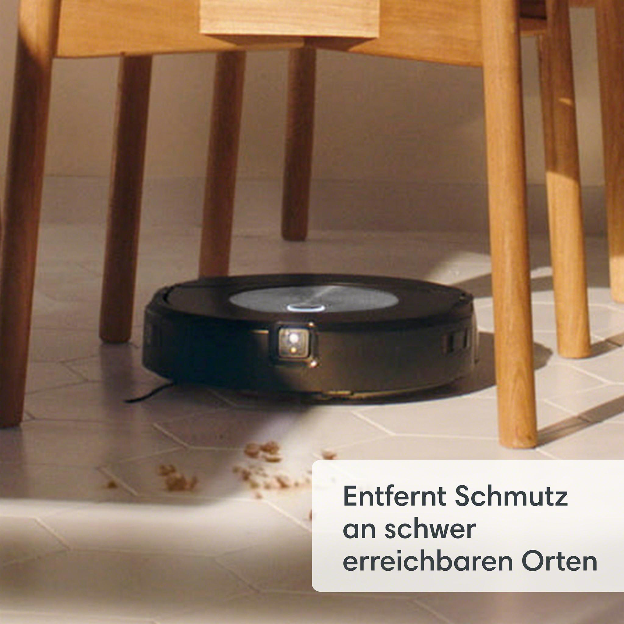 Roboter-Staubsauger auf Fliesenboden, Reinigung in der Nähe eines Tisches.