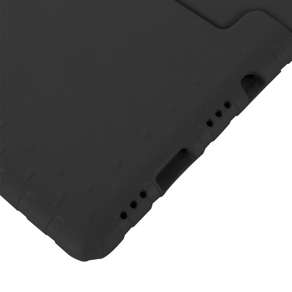Close up of a black surface with small circular indentations.