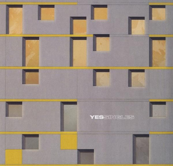 YES Singles album borító. Szürke épület sárga téglalap és négyzet alakú díszítéssel.