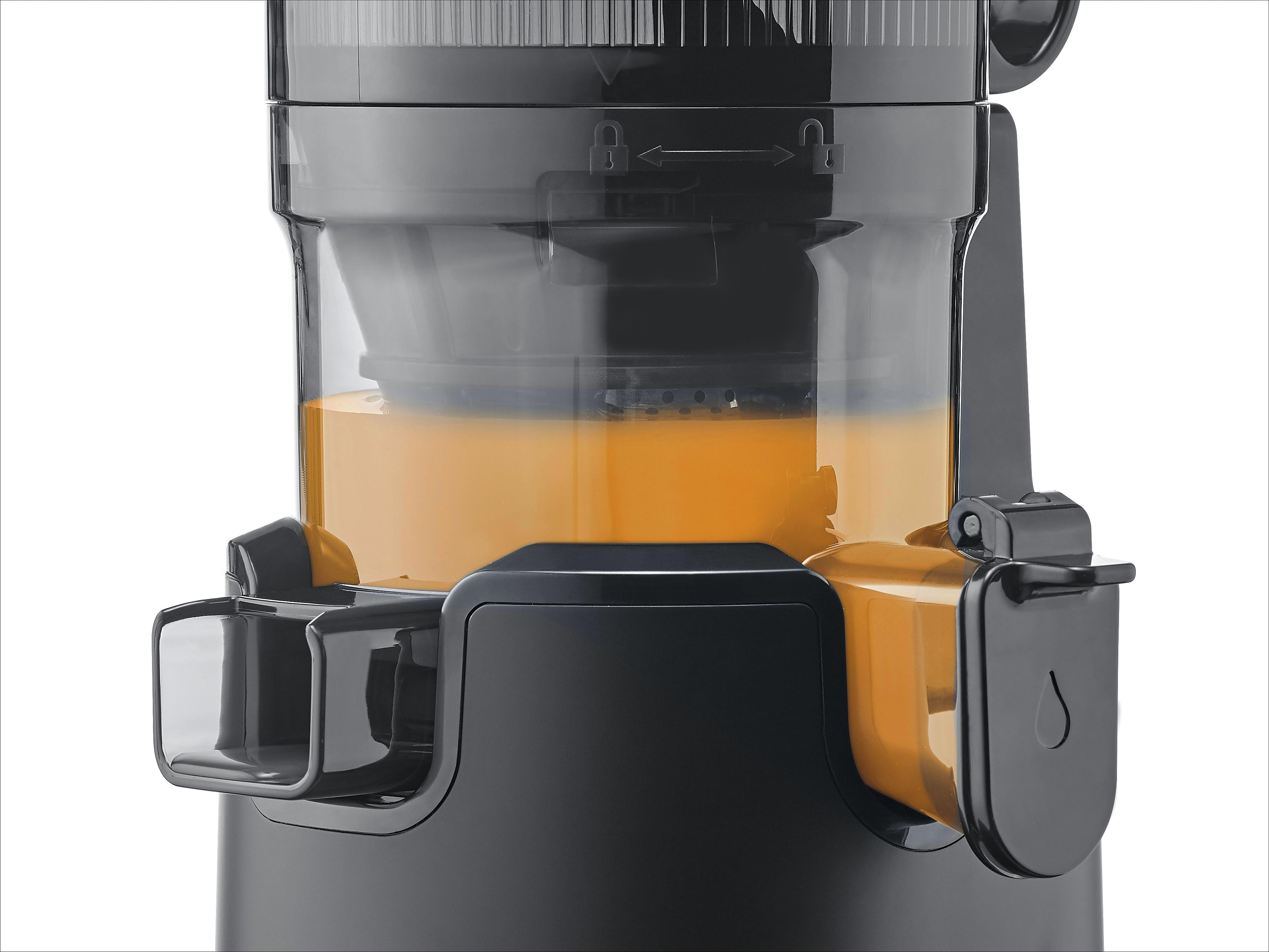 Nahaufnahme eines Entsafters mit Saft und schwarzem Sockel.