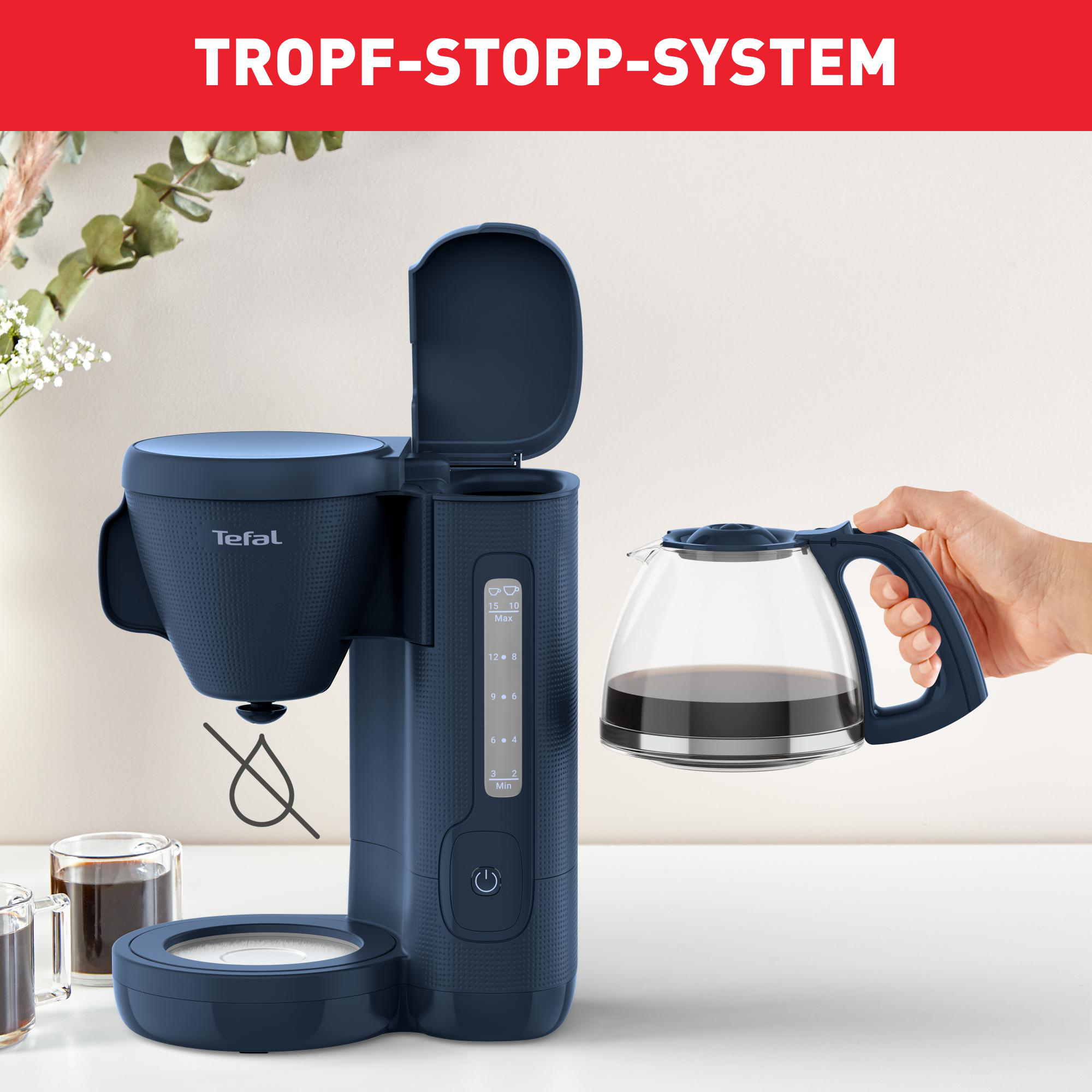 Blaue Tefal Kaffeemaschine mit Glaskanne. Hand gießt Kaffee ein. Text "TROPF-STOPP-SYSTEM" oben.
