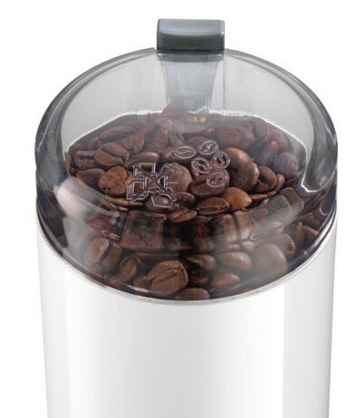 Ziarna kawy wewnątrz białego młynka elektrycznego.