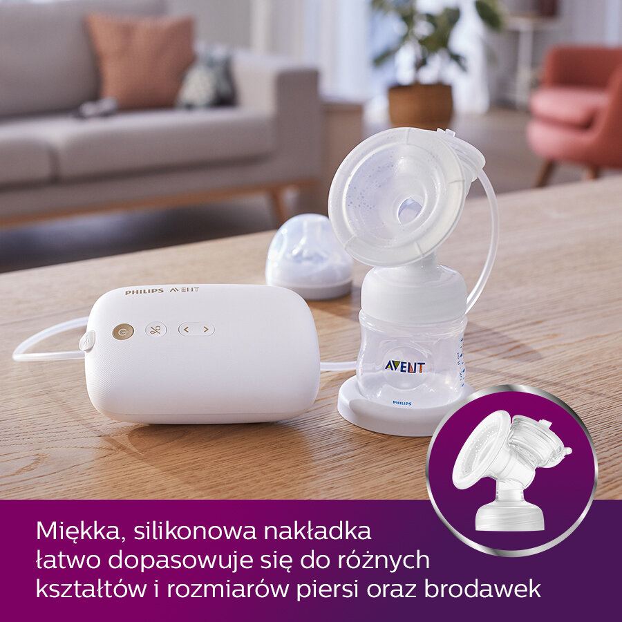 Biała laktator Philips Avent z akcesoriami na drewnianym stole.